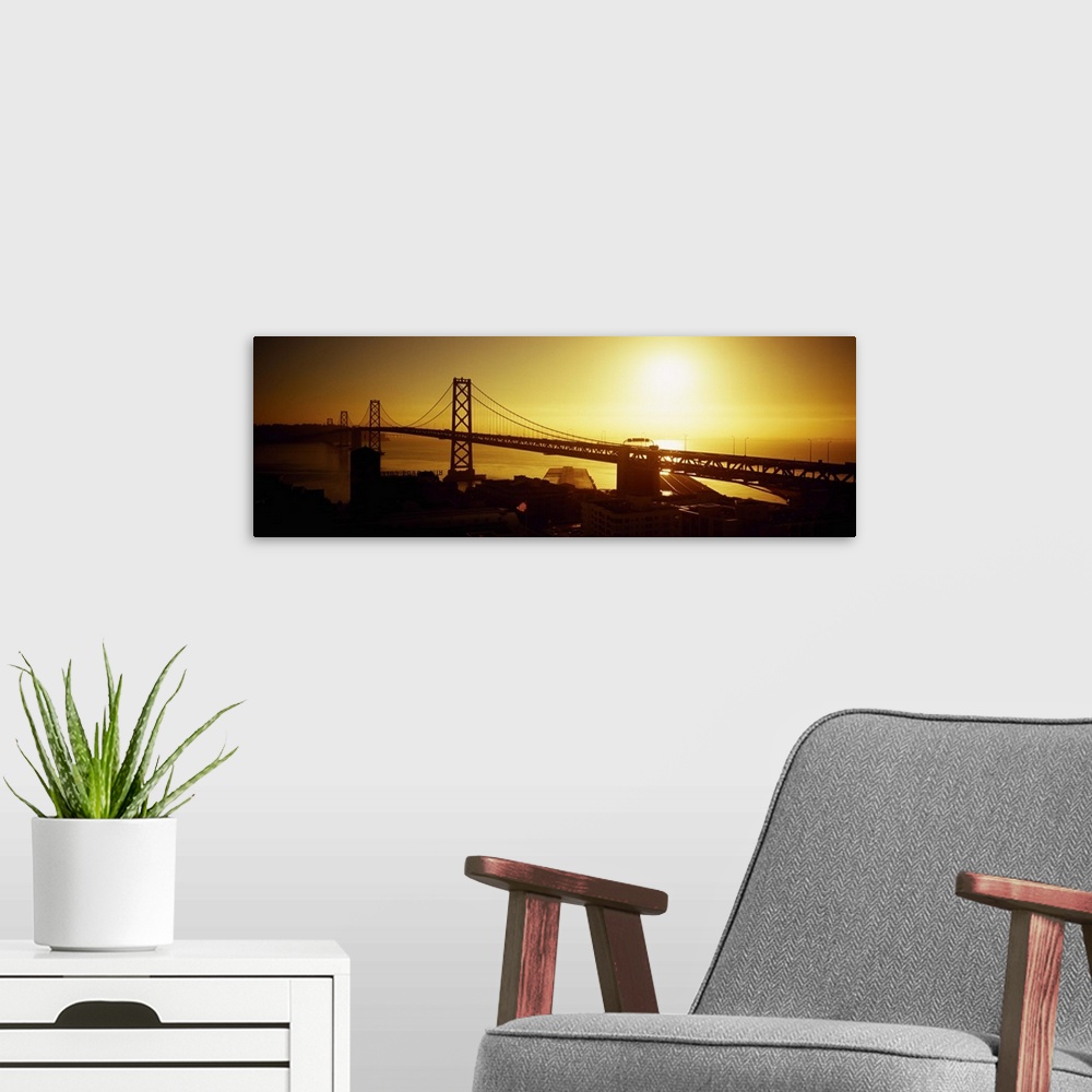 A modern room featuring High angle view of a suspension bridge at sunset, Bay Bridge, San Francisco, California