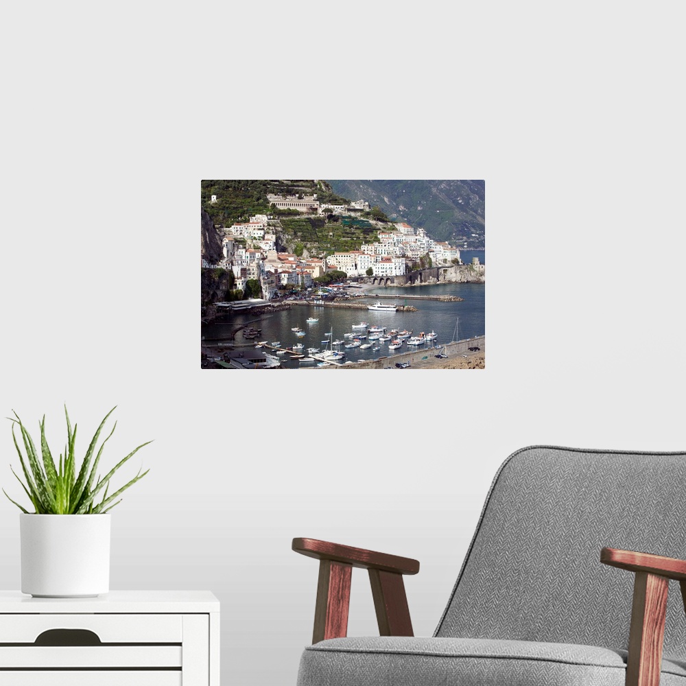 A modern room featuring Photograph of busy port town with boats coming in to dock.  Part of the water's edge is made of m...