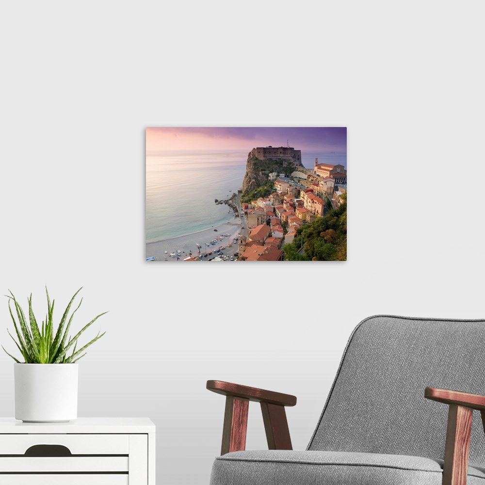 A modern room featuring Large photograph taken of a fortress on the edge of a cliff with houses and buildings nearby as t...