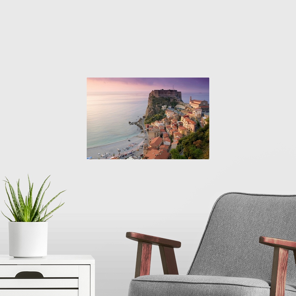 A modern room featuring Large photograph taken of a fortress on the edge of a cliff with houses and buildings nearby as t...