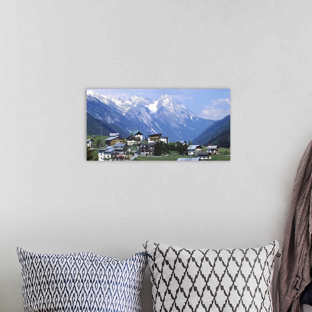 A bohemian room featuring High angle view of a village on a landscape and a mountain range in the background, St. Anton, Au...