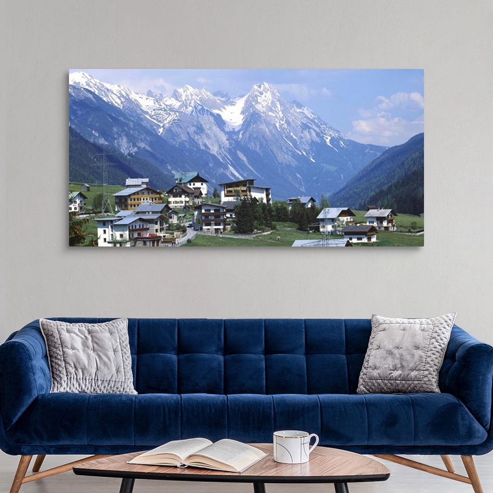 A modern room featuring High angle view of a village on a landscape and a mountain range in the background, St. Anton, Au...