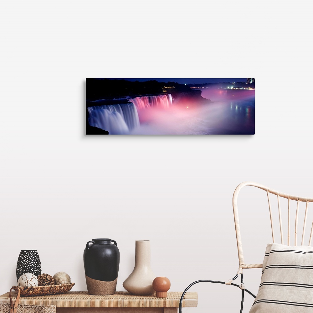 A farmhouse room featuring Panoramic photograph of wide stretching waterfall at night with fog rising from the bottom.  Ther...