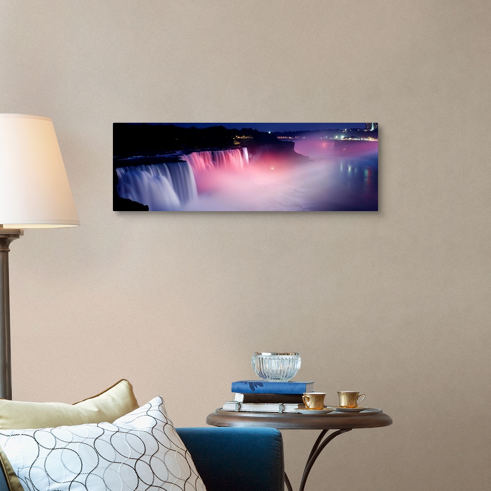 A traditional room featuring Panoramic photograph of wide stretching waterfall at night with fog rising from the bottom.  Ther...