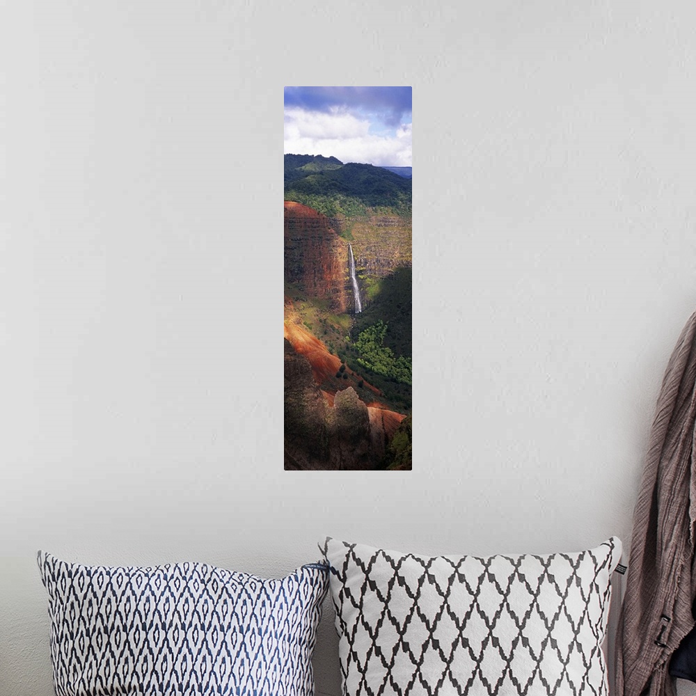 A bohemian room featuring Tall photo on canvas of a waterfall flowing off of a giant cliff seen from a distance.