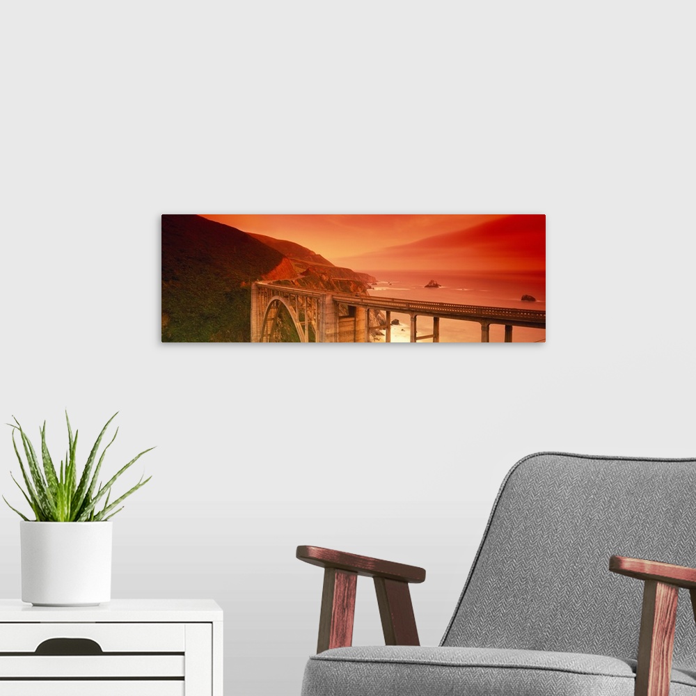 A modern room featuring Oversized, horizontal photograph of the Bixby Bridge, next to the cliffs of Big Sur, California, ...