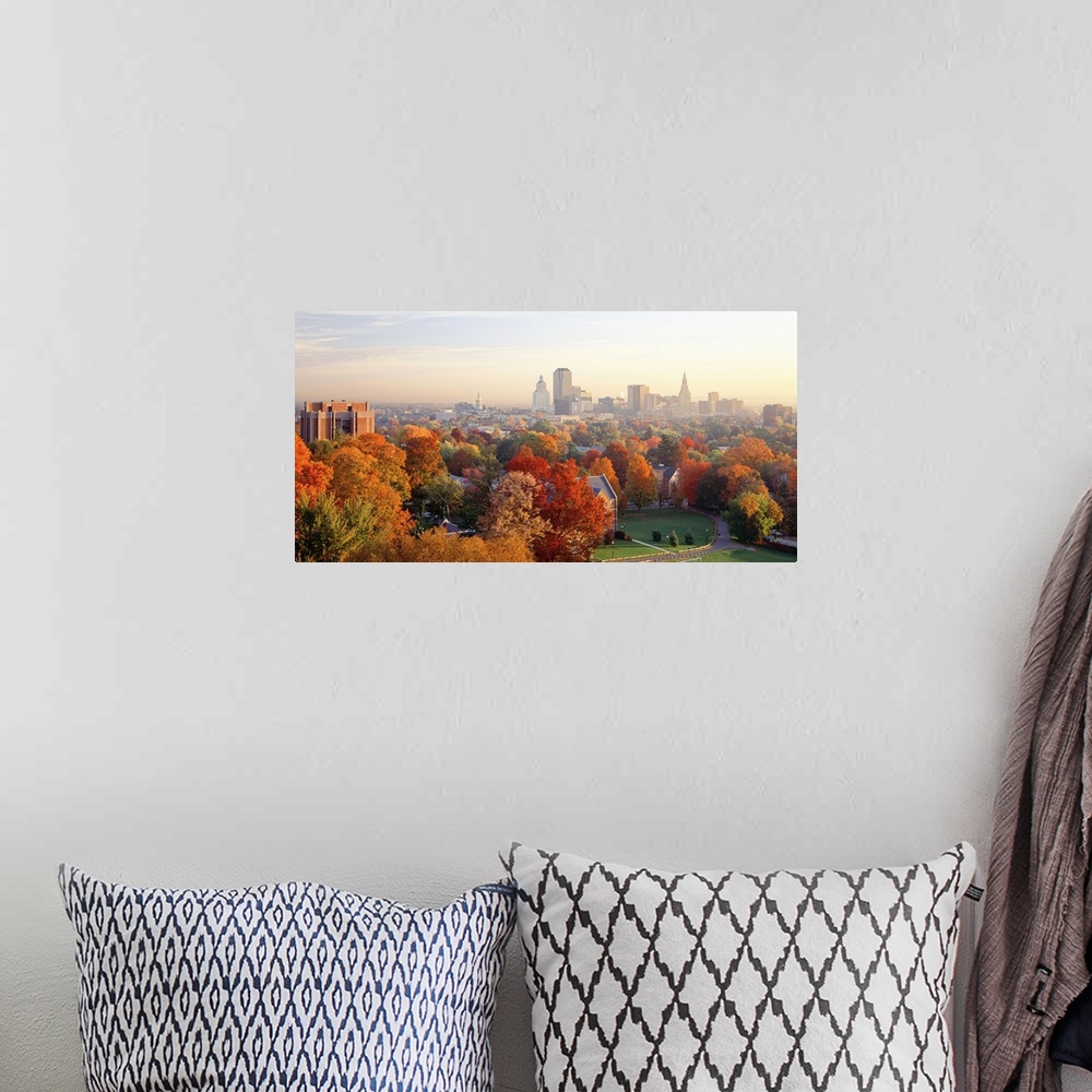 A bohemian room featuring Fall foliage in bright colors with views of the city of Hartford, CT in the background.