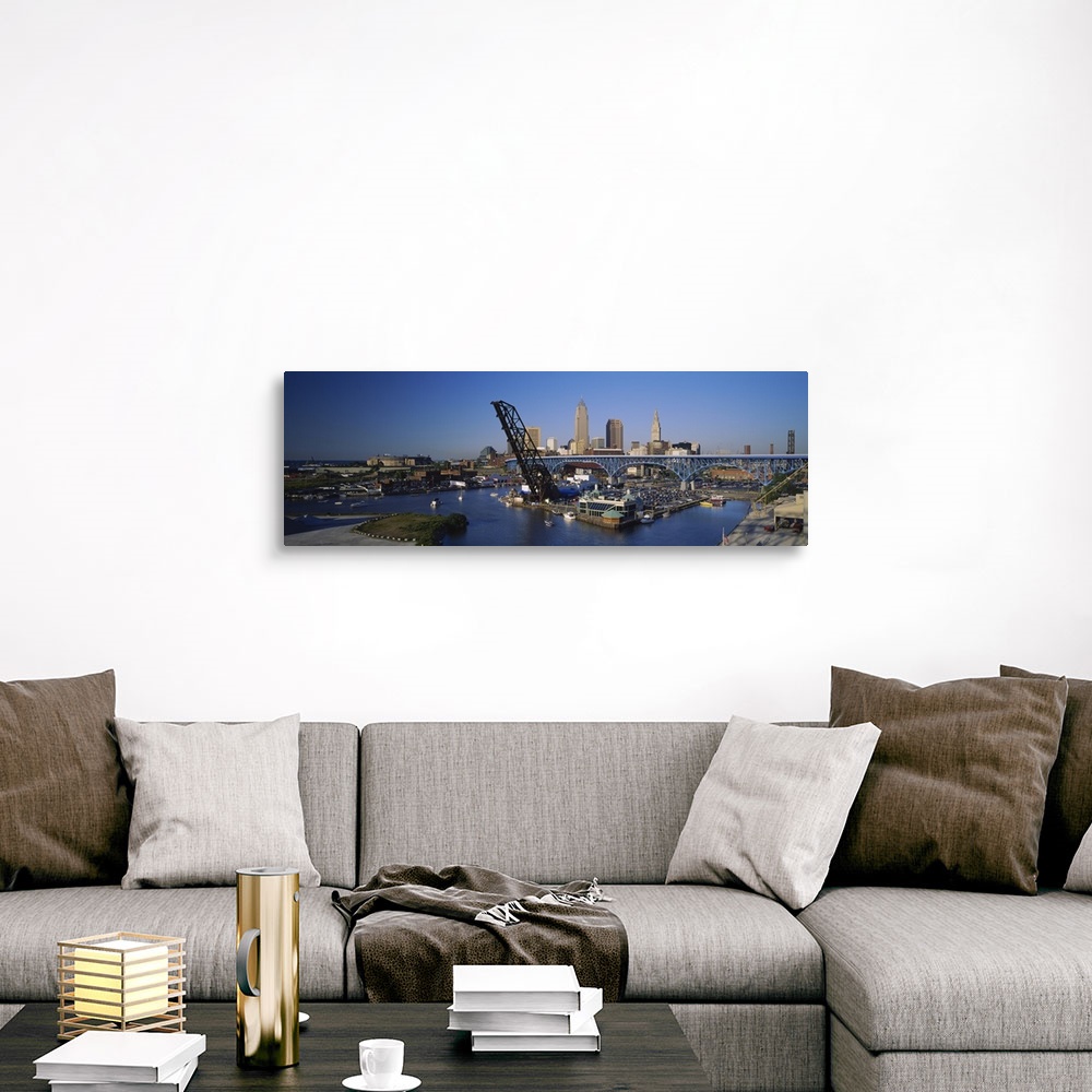 A traditional room featuring Panoramic photograph of bridge with port and sailboats below with skyline in the distance under a...