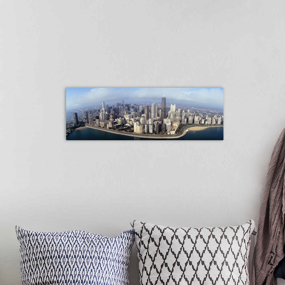 A bohemian room featuring Panoramic photograph of cityscape and waterfront under a cloudy sky.