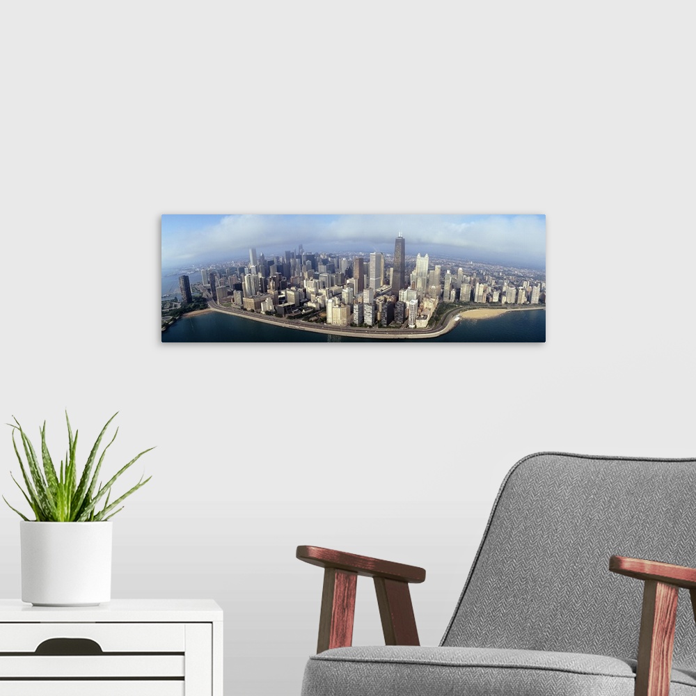 A modern room featuring Panoramic photograph of cityscape and waterfront under a cloudy sky.