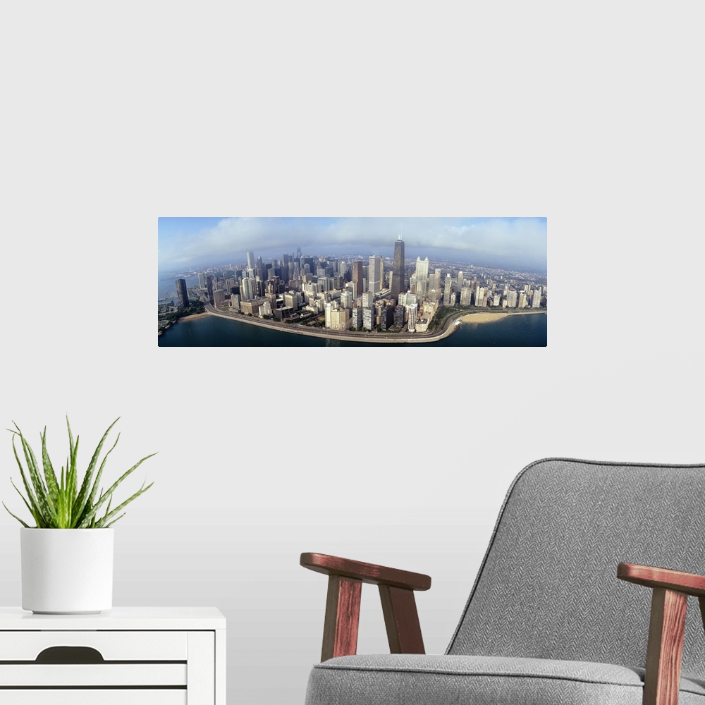 A modern room featuring Panoramic photograph of cityscape and waterfront under a cloudy sky.