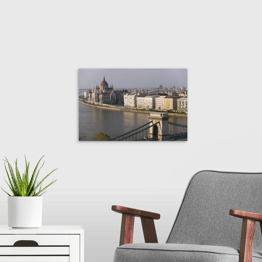 A modern room featuring High angle view of buildings at the waterfront, Parliament Building, Chain Bridge, Danube River, ...