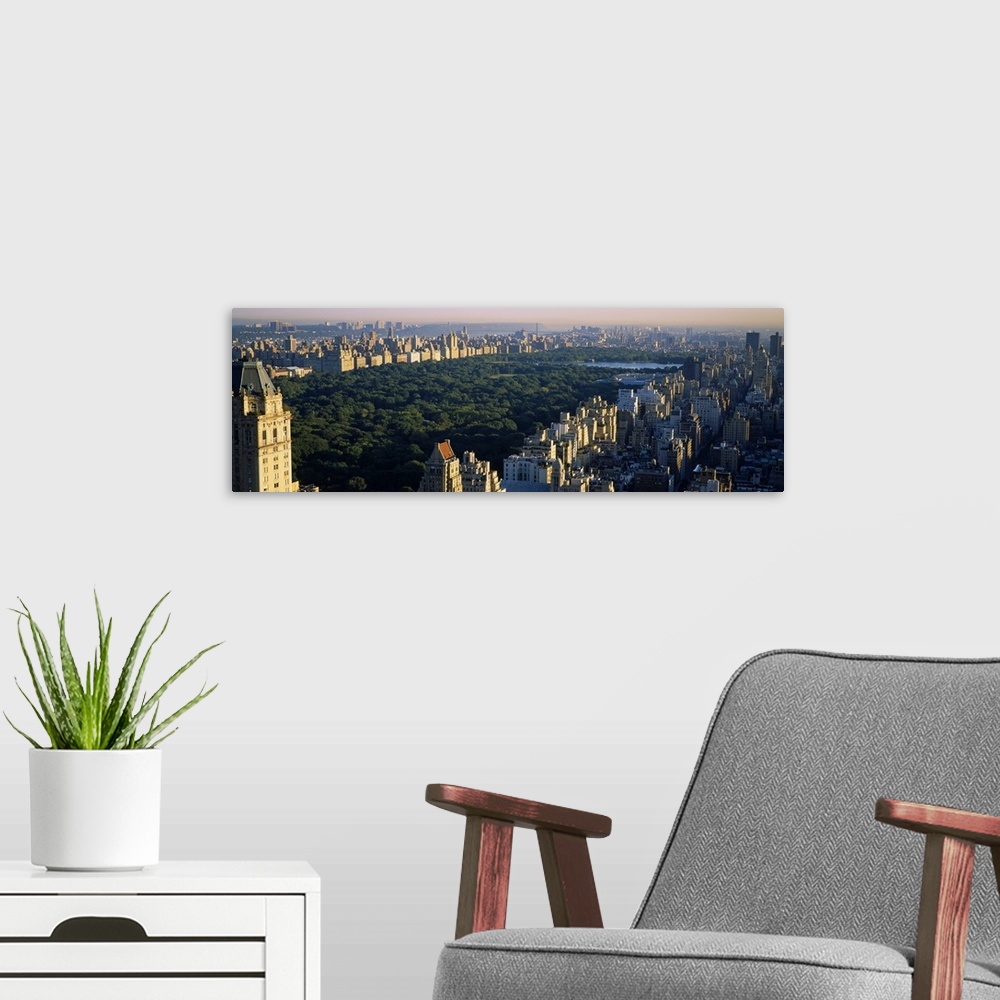 A modern room featuring Panoramic canvas photo of the trees and lake in Central Park surrounded by the buildings of the c...