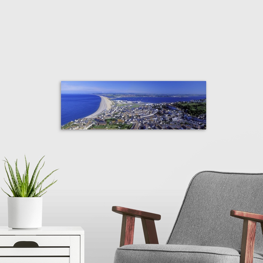 A modern room featuring High angle view of buildings in a city, Chesil Beach, Portland, Isle of Portland, Dorset, England