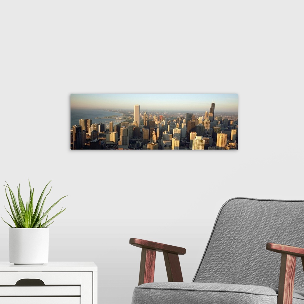 A modern room featuring This panoramic canvas is an aerial photograph of the city skyline.