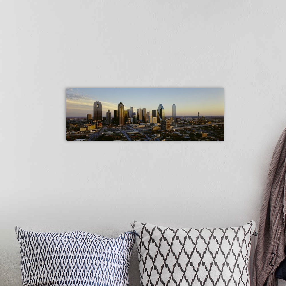 A bohemian room featuring Buildings in the Dallas skyline are photographed in panoramic view during dawn.
