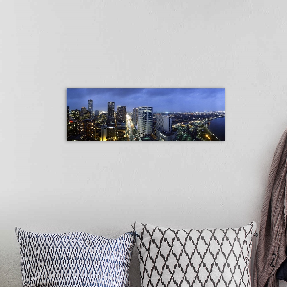 A bohemian room featuring Giant, landscape, high angle photograph of the New Orleans skyline, lit at night, beneath a deep ...