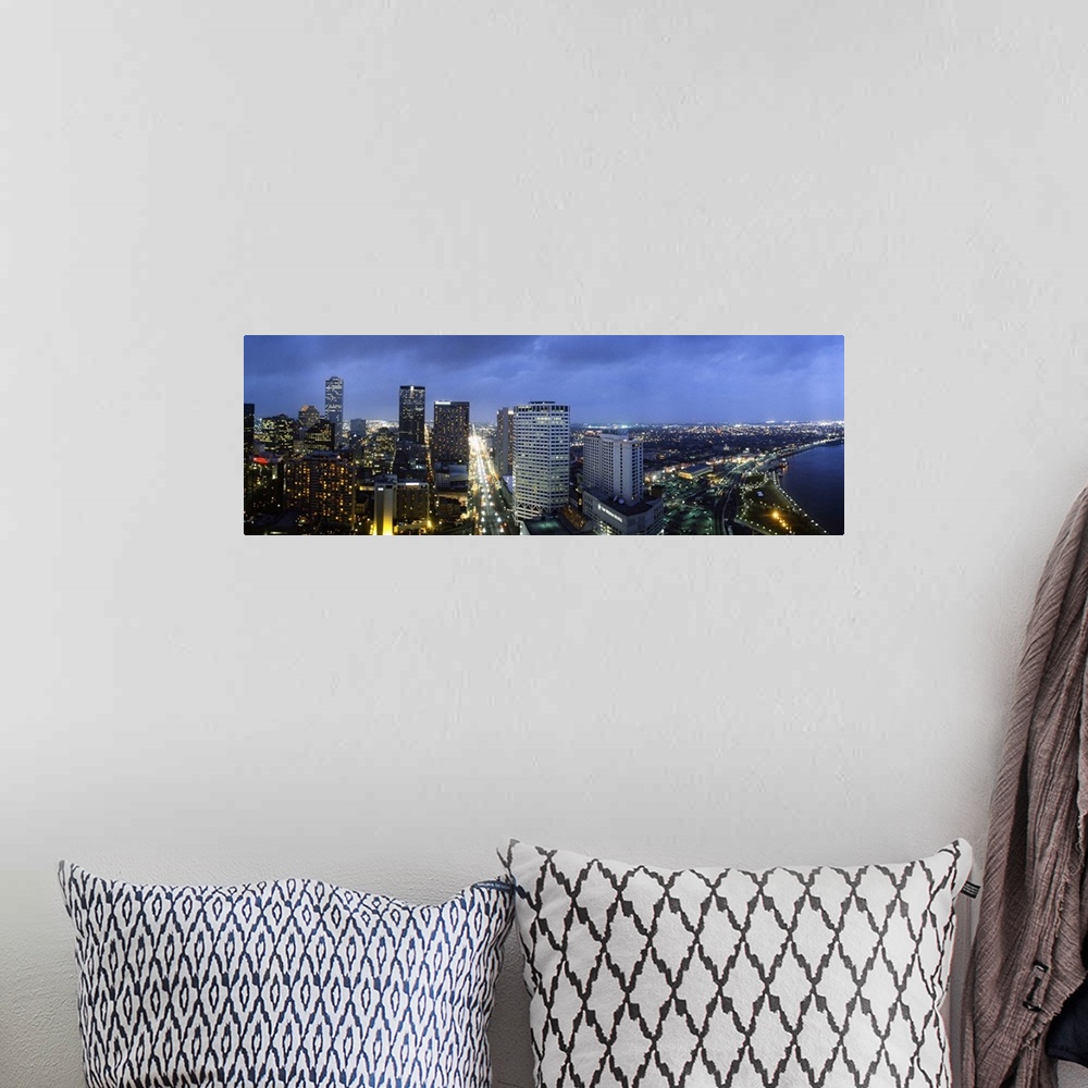 A bohemian room featuring Giant, landscape, high angle photograph of the New Orleans skyline, lit at night, beneath a deep ...