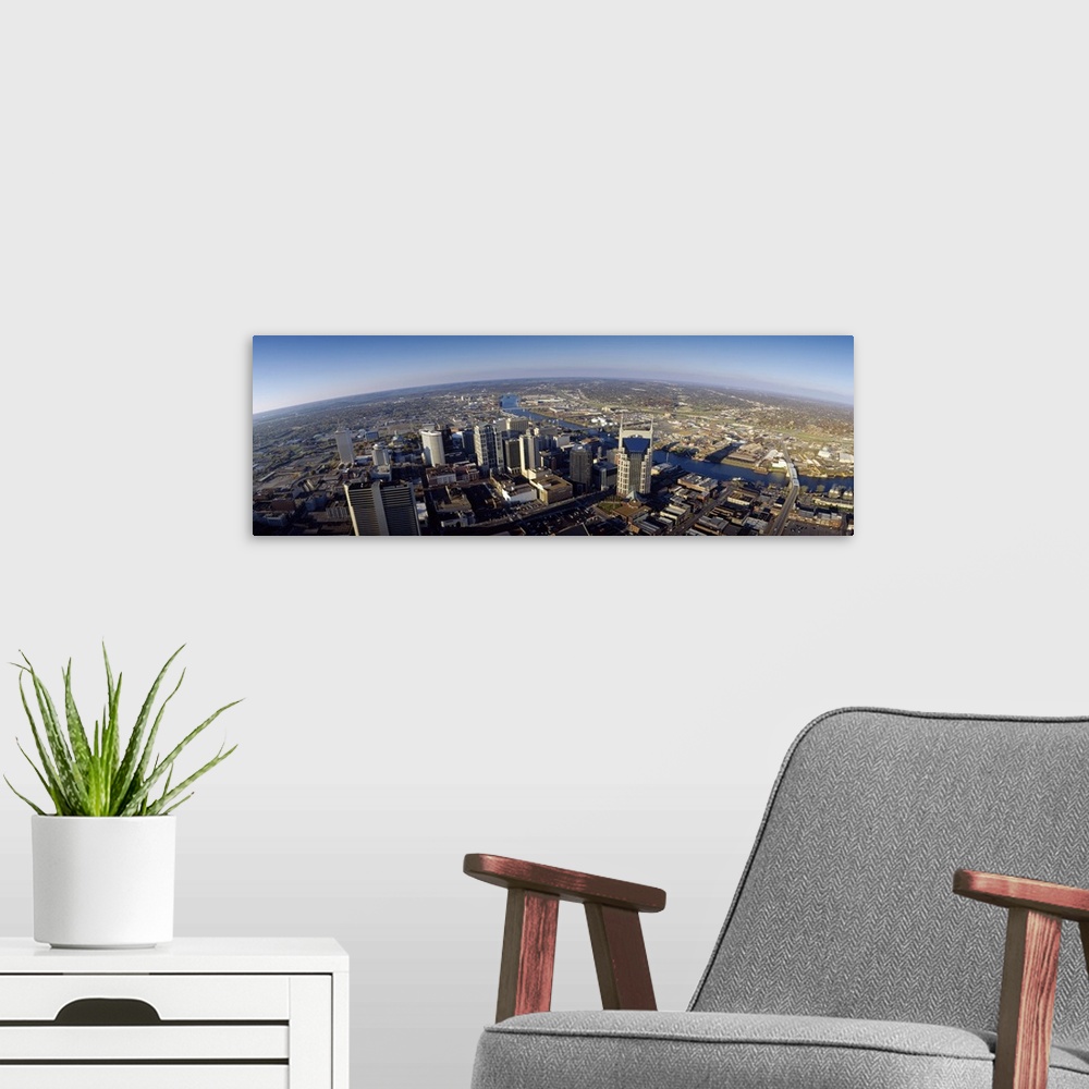 A modern room featuring An aerial photograph taken in panoramic view of the city of Nashville during the day.