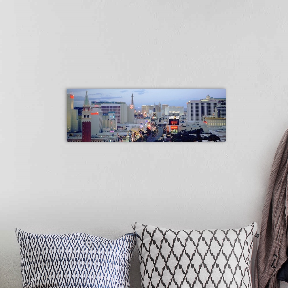 A bohemian room featuring Panoramic photograph taken of part of the strip in Las Vegas during dusk.