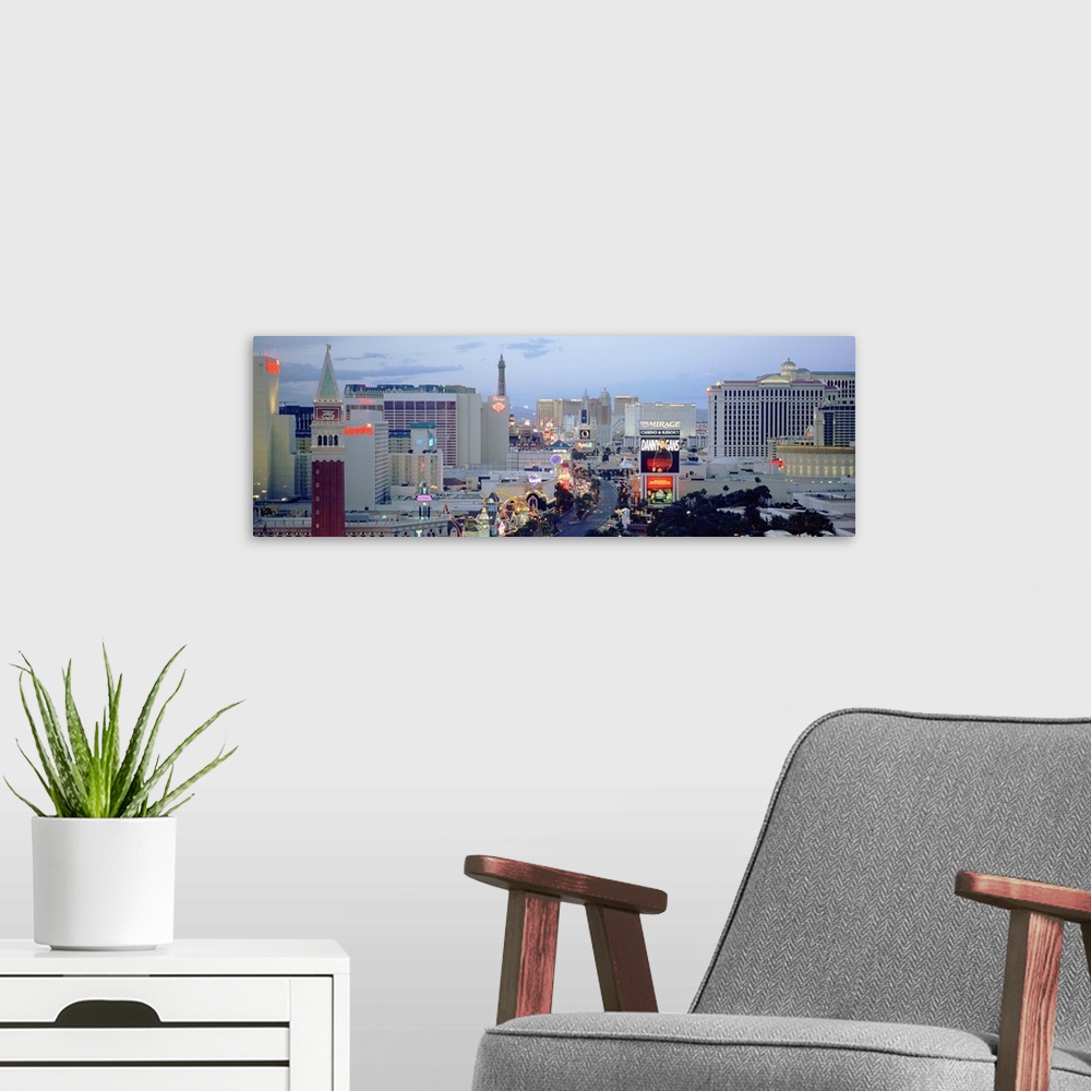 A modern room featuring Panoramic photograph taken of part of the strip in Las Vegas during dusk.