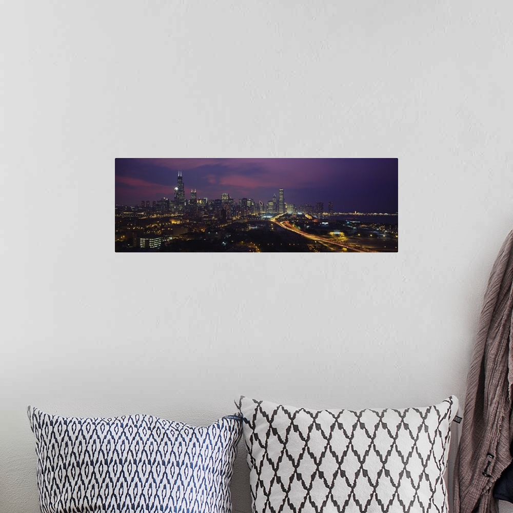 A bohemian room featuring Panoramic photograph from above of the lights of the Chicago city skyline at night.