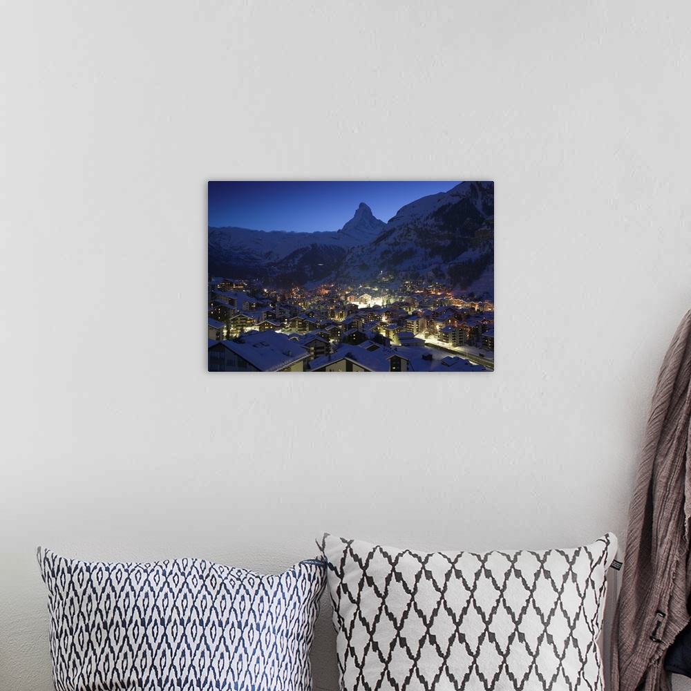 A bohemian room featuring Photograph of city from above at night with snow covered foothills in the distance.