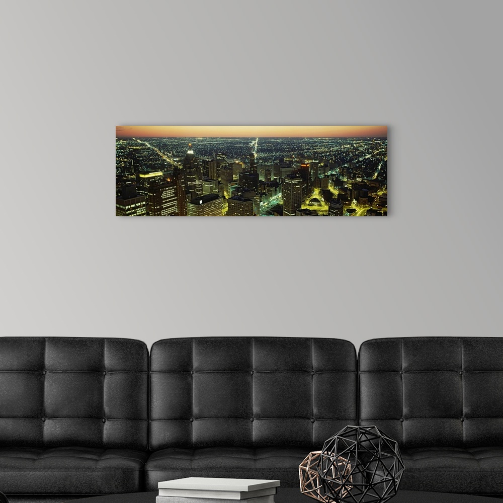 A modern room featuring Panoramic photograph taken from an aerial view at nighttime overlooks the sea of lights coming of...