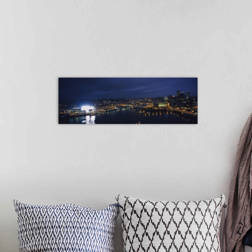 A bohemian room featuring Panoramic photograph of skyline  and waterfront at dusk with building lights on.