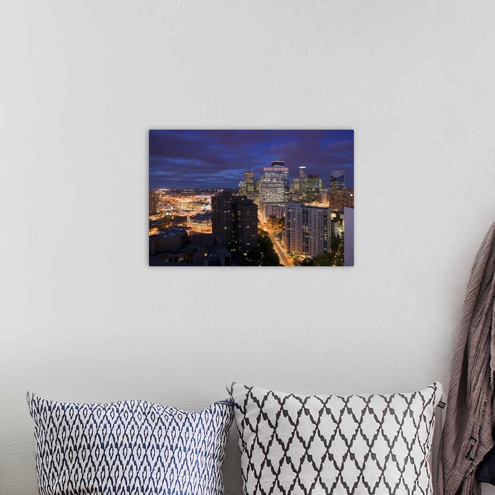 A bohemian room featuring This photograph is taken of downtown Minneapolis at night from atop a building and looking straig...