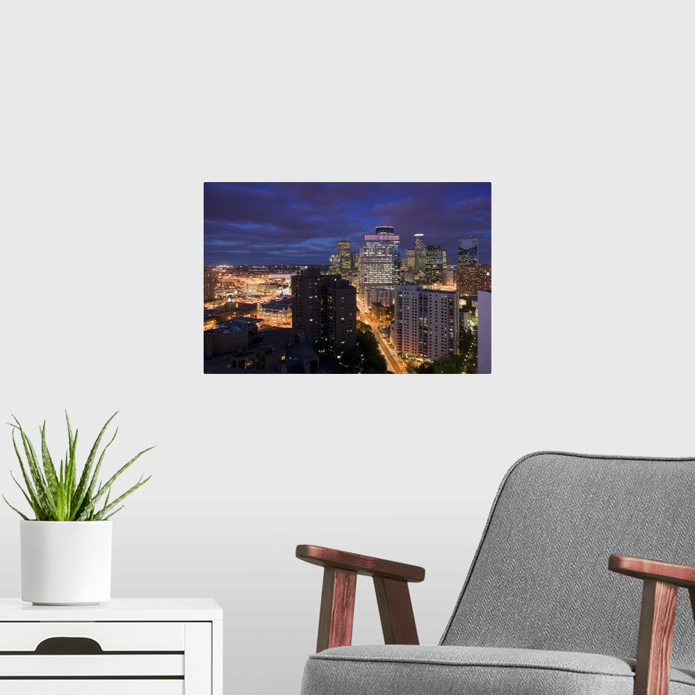 A modern room featuring This photograph is taken of downtown Minneapolis at night from atop a building and looking straig...