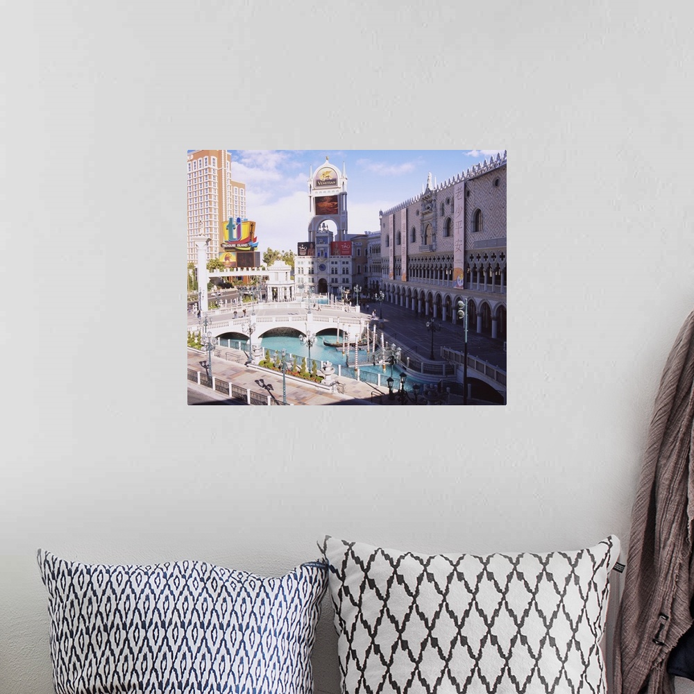 A bohemian room featuring High angle view of footbridge over a pond in front of buildings, Venetian Hotel, Treasure Island ...
