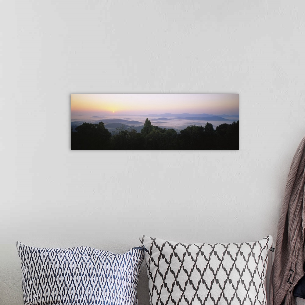 A bohemian room featuring Large panoramic photograph of mountains in Virginia with the sun setting far in the distance and ...