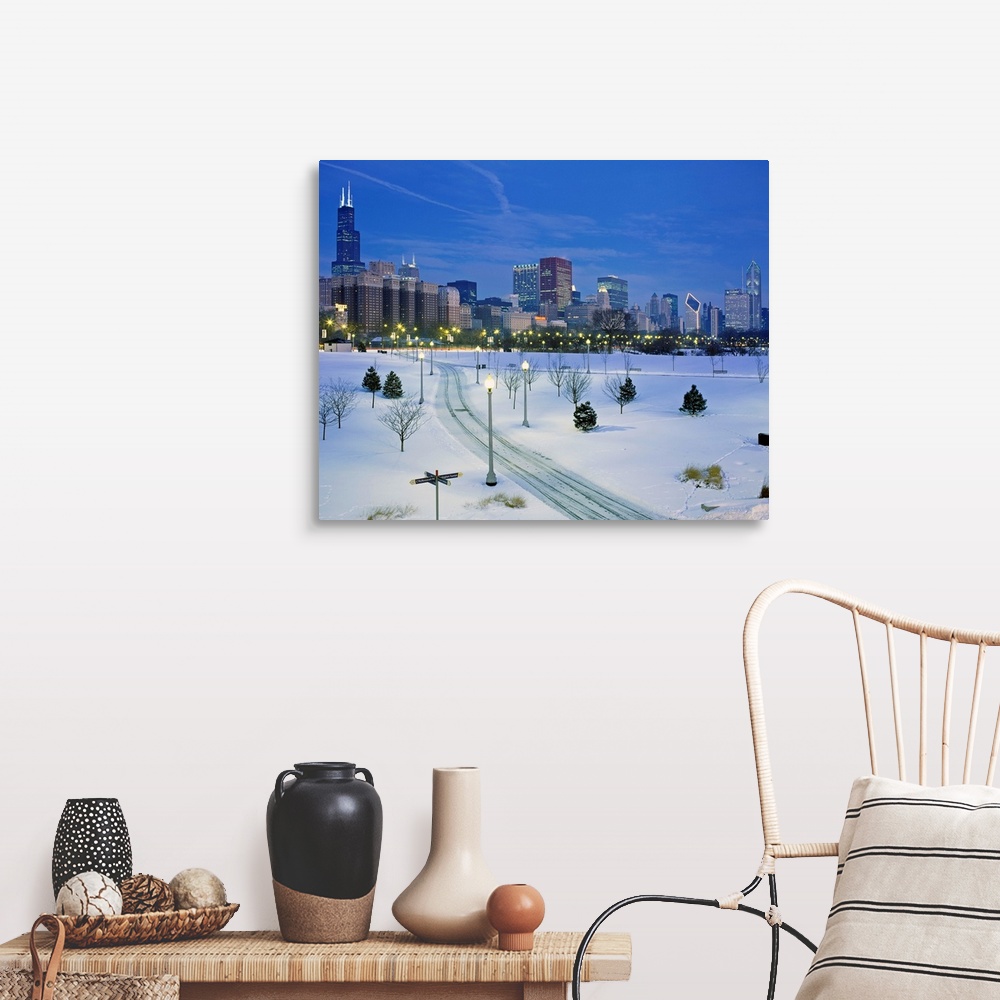 A farmhouse room featuring A photograph of a city park buried in fresh snow and the city skyscrapers available of as a large...