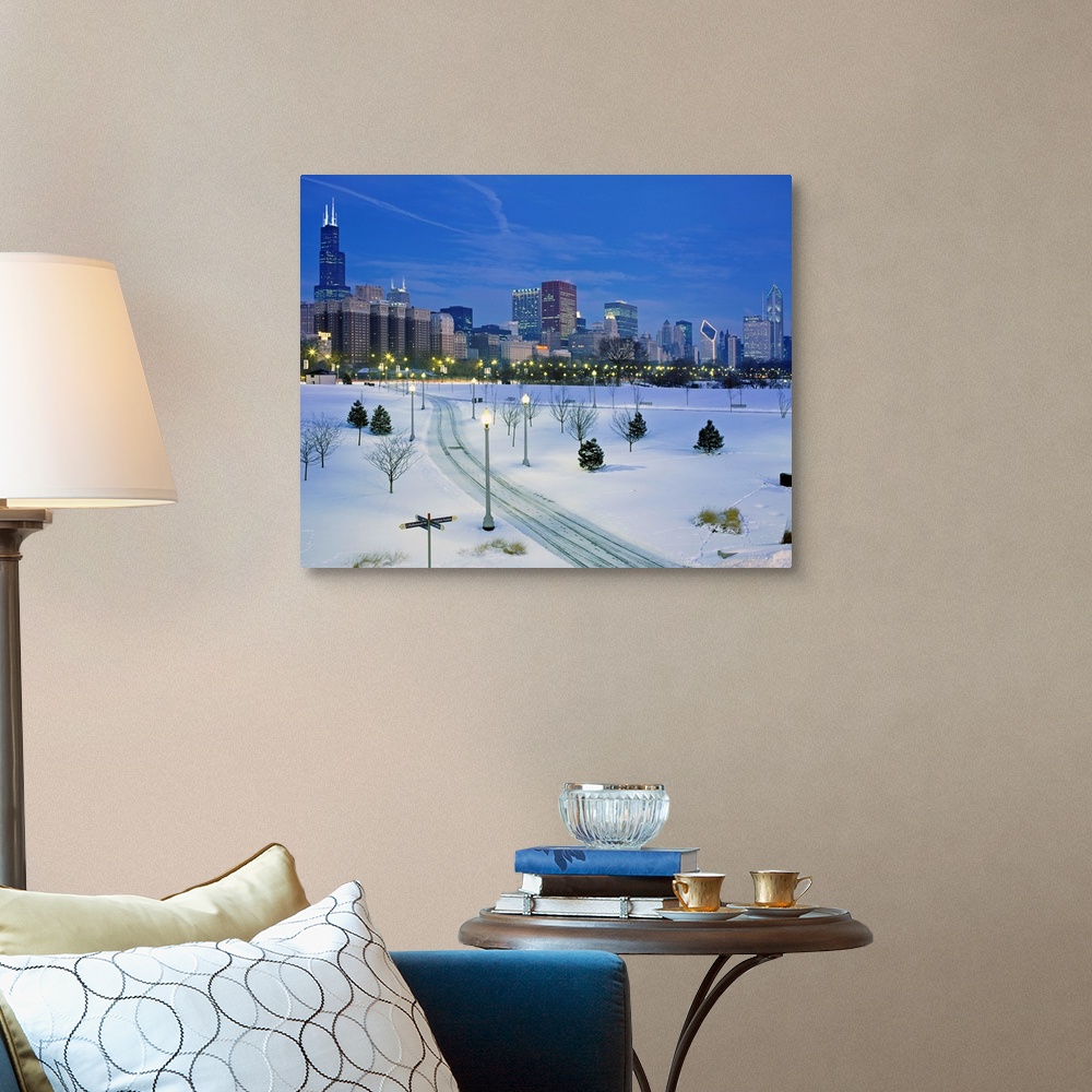 A traditional room featuring A photograph of a city park buried in fresh snow and the city skyscrapers available of as a large...