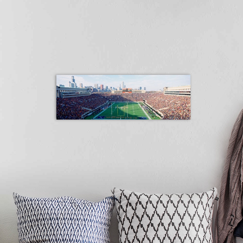 A bohemian room featuring Panoramic photograph of a football stadium with the stands packed with fans ready to watch the Ch...