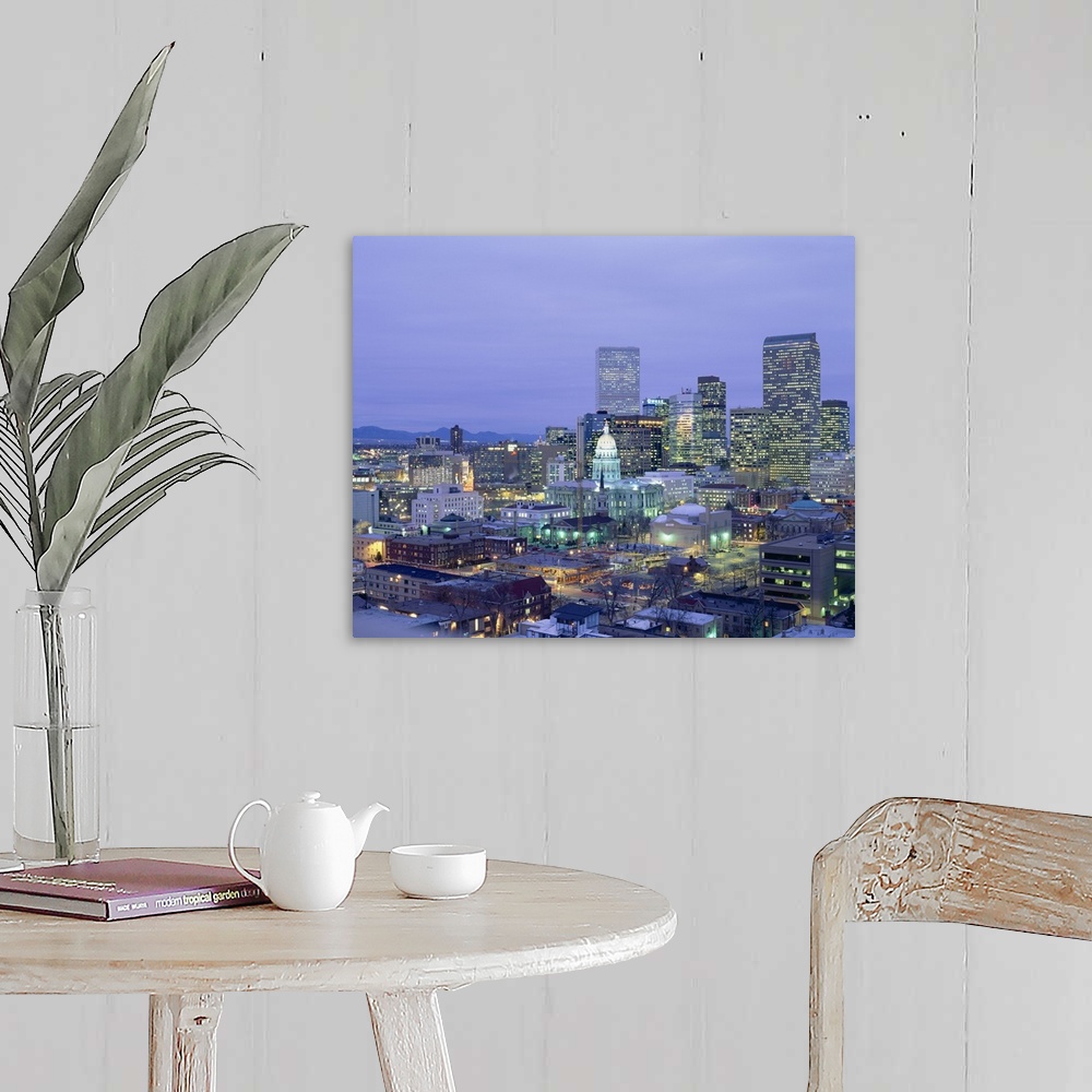 A farmhouse room featuring Square canvas photo of a illuminated city at dusk with mountains in the left background.
