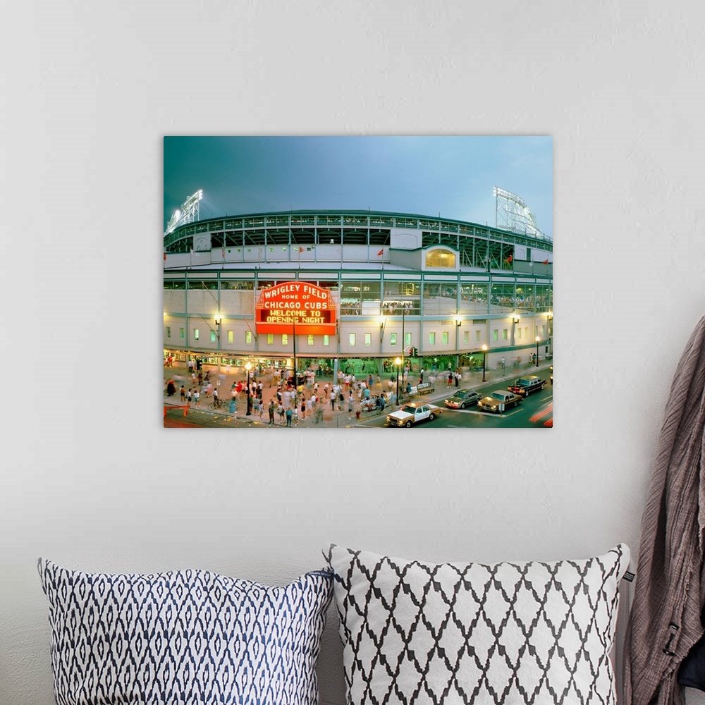 A bohemian room featuring A horizontal photograph showing an entrance and sign to Chicagoos beloved baseball stadium.
