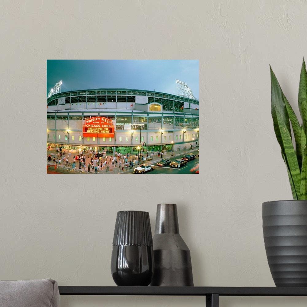 A modern room featuring A horizontal photograph showing an entrance and sign to Chicagoos beloved baseball stadium.
