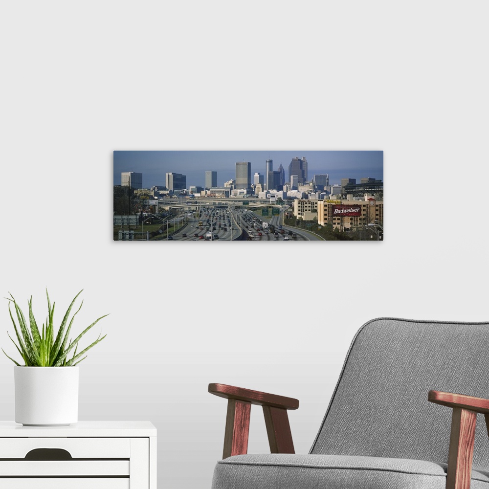 A modern room featuring Wide angle view of the skyline and roads leading into the city of Atlanta.