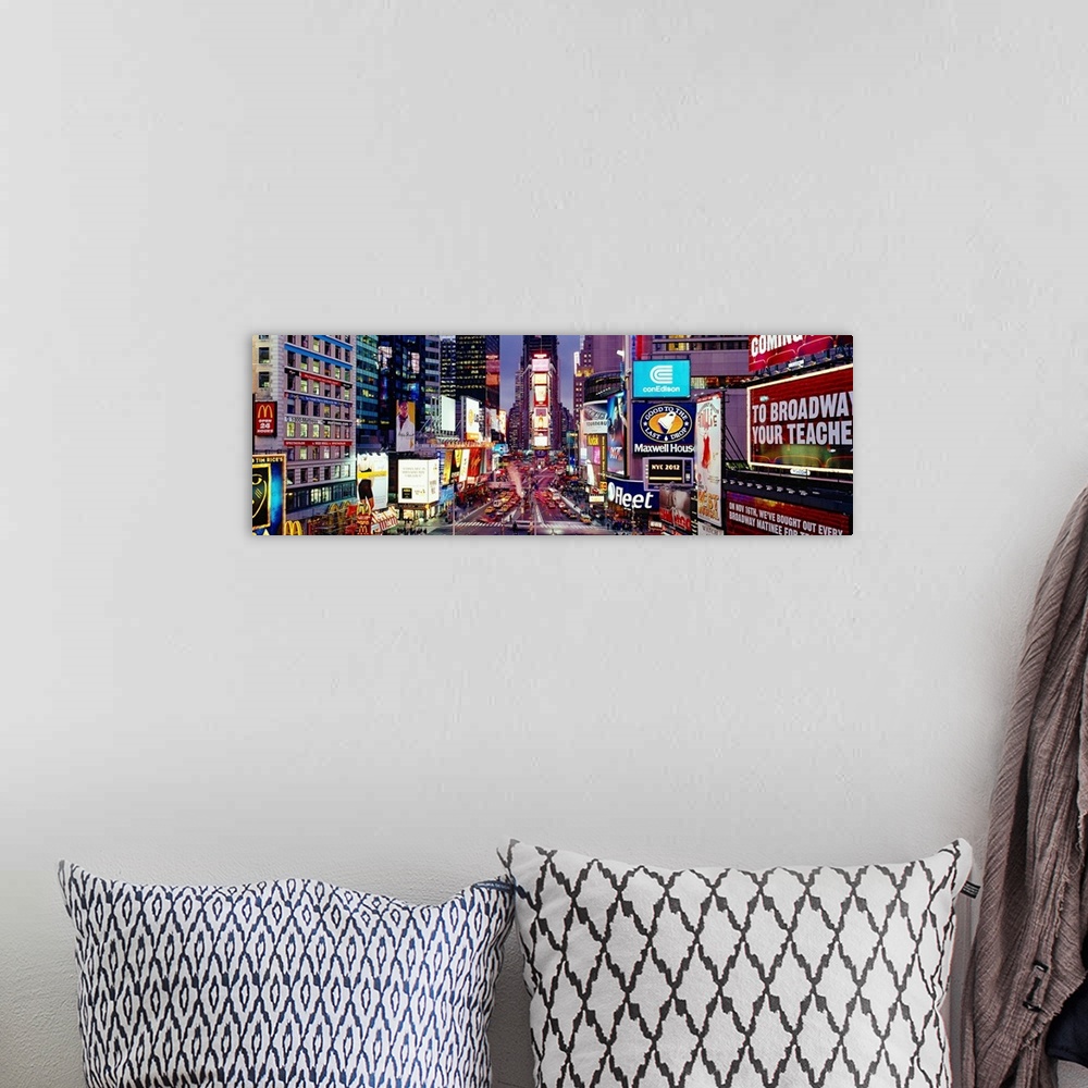 A bohemian room featuring Panoramic photograph of neon signs and city streets downtown.