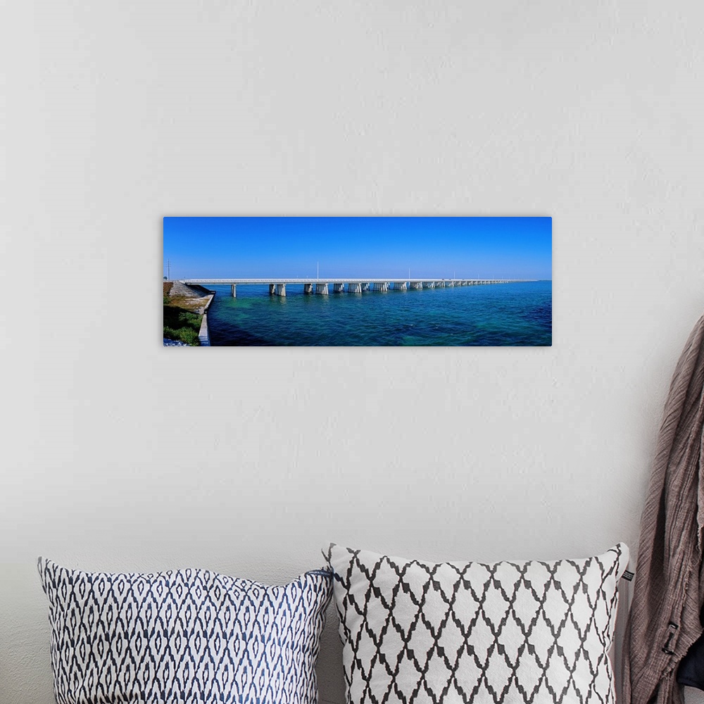 A bohemian room featuring Big panoramic photo print of a long bridge going over the ocean.