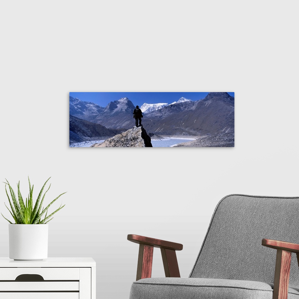 A modern room featuring Hiker standing on a rock, Gokyo Valley, Khumbu, Nepal