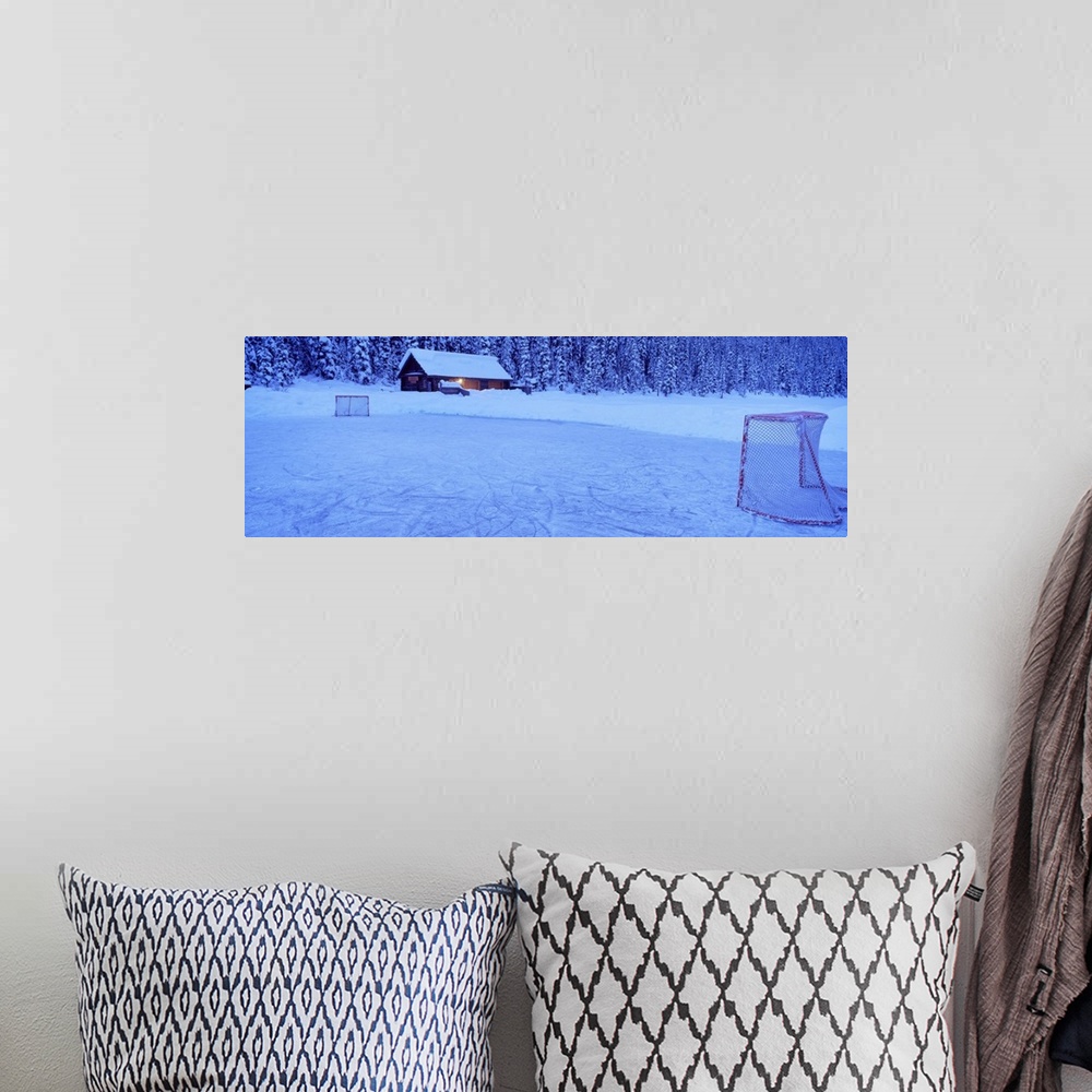 A bohemian room featuring Wall art for the home or cabin this panoramic photograph shows a cabin buried in snow next to a f...