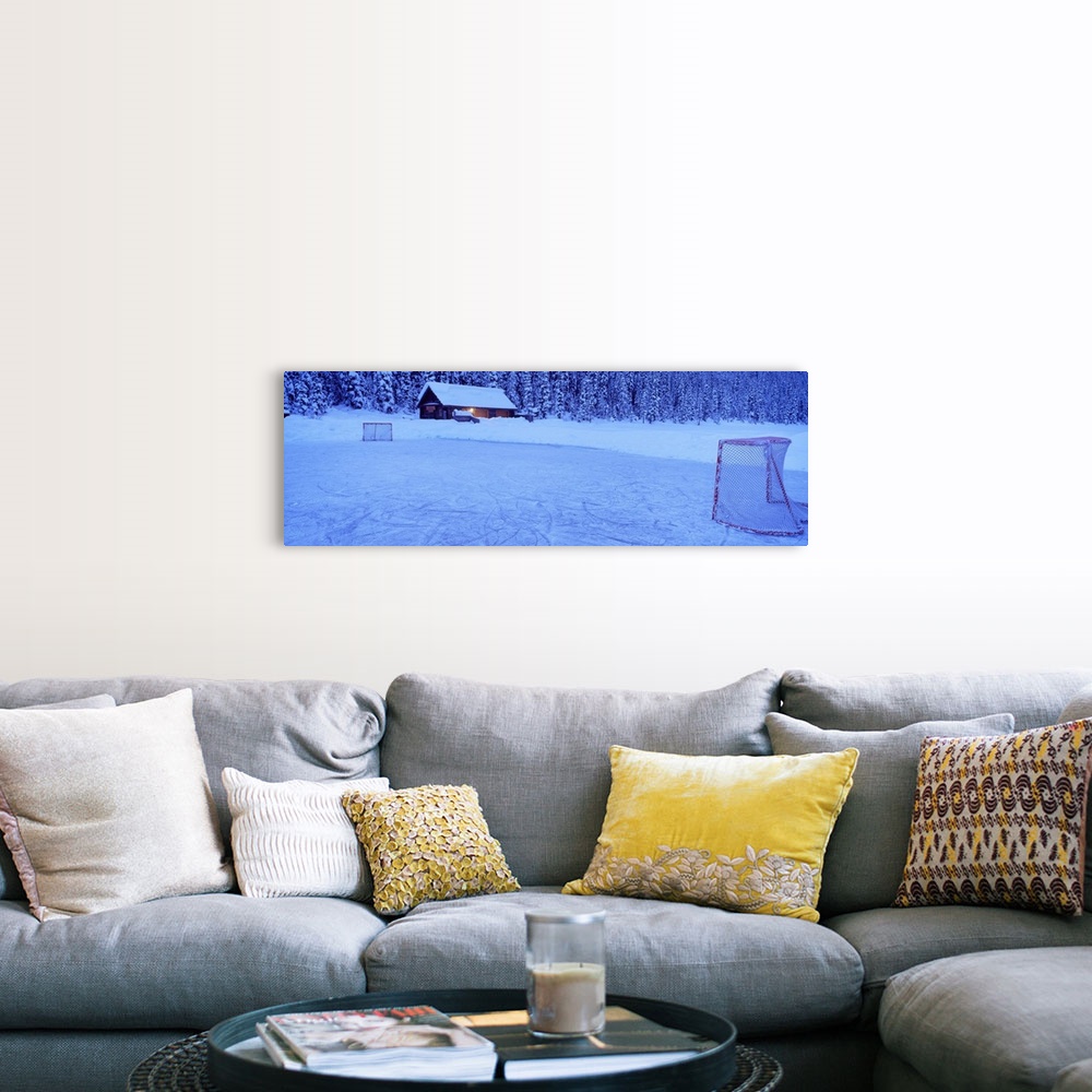 A farmhouse room featuring Wall art for the home or cabin this panoramic photograph shows a cabin buried in snow next to a f...