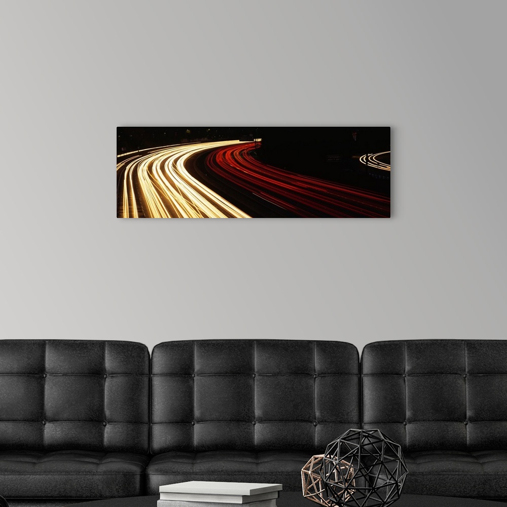 A modern room featuring Trails of car lights on the busy Hollywood Freeway in the evening in California.