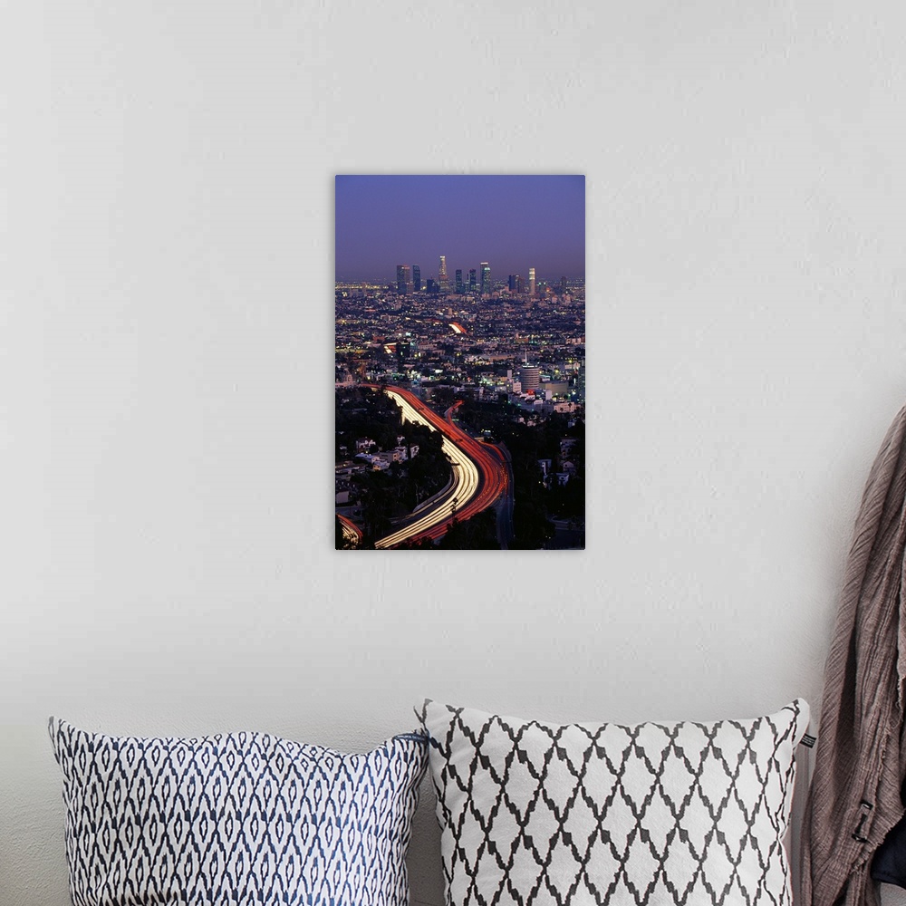 A bohemian room featuring Vertical panoramic of highway running through busy west coast metropolis with city skyline in dis...