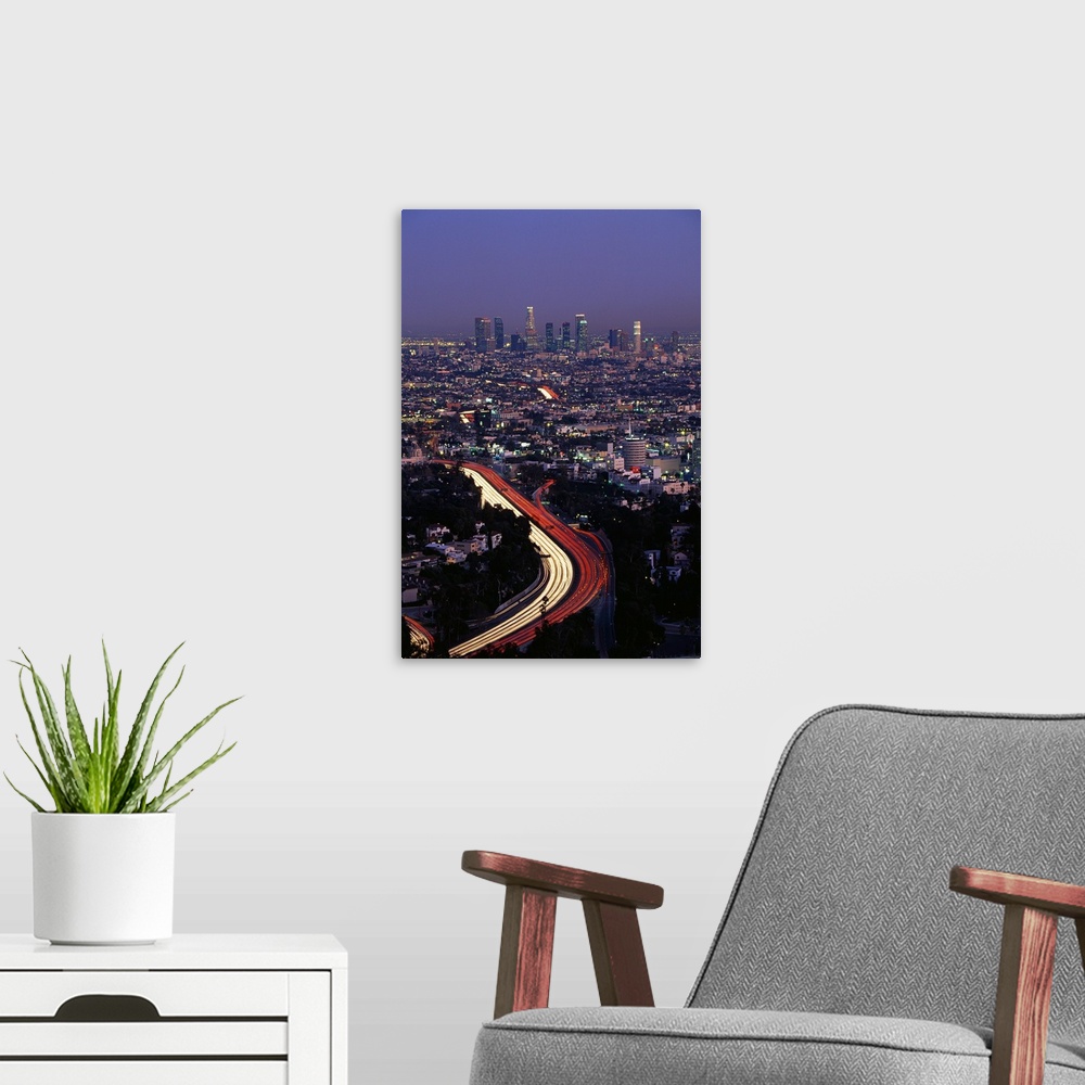 A modern room featuring Vertical panoramic of highway running through busy west coast metropolis with city skyline in dis...