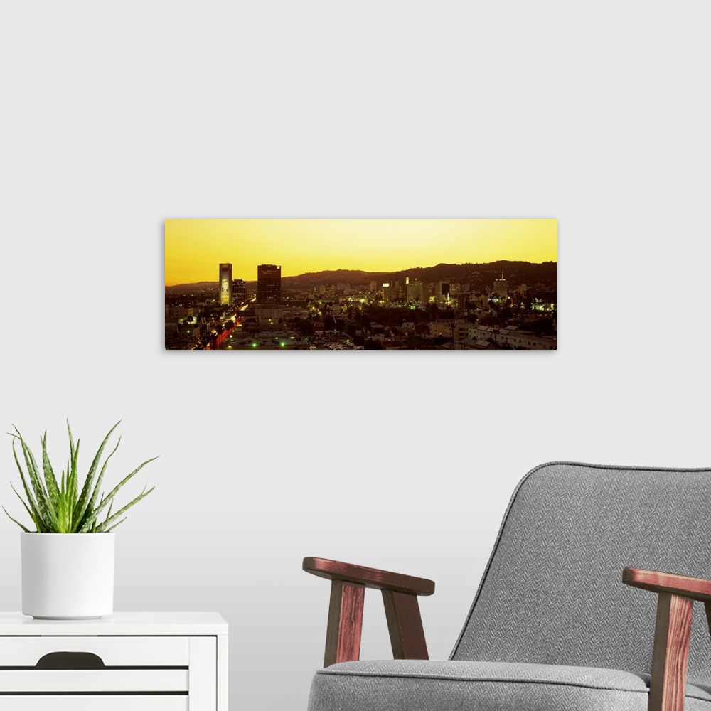 A modern room featuring Oversized, high angle photograph of the Hollywood Hills, lit up at sunset, in Hollywood California.