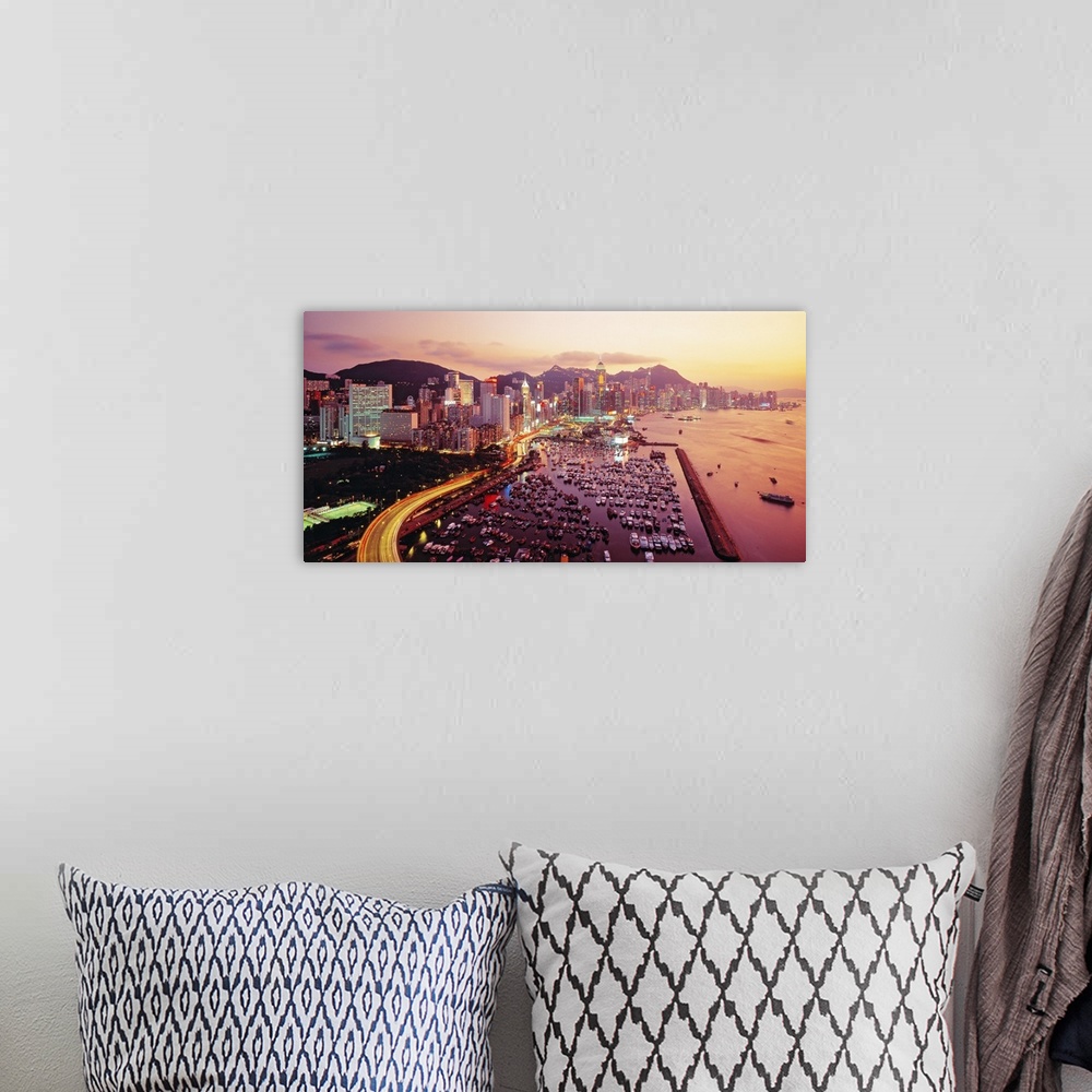 A bohemian room featuring Large photograph of a harbor in Hong Kong at sunset. Hundreds of boats and many buildings can be ...